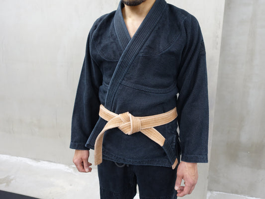 A well-used BJJ gi showing the changes that occur through repeated training and washing.