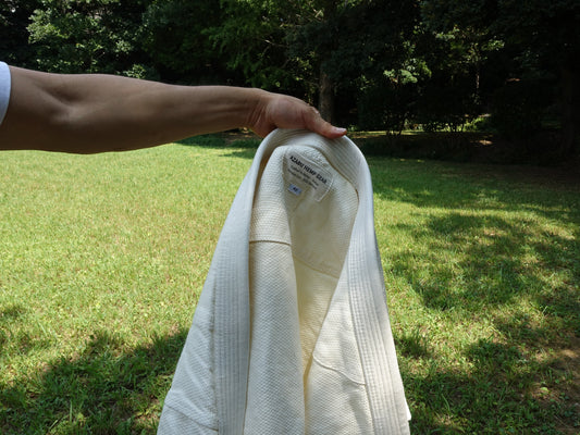White hemp BJJ gi worn outdoors in natural light during summer